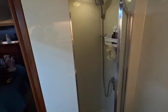 Slide: The Image of Shower area in 1987 Californian 45 Motor Yacht, featuring compact design and modern fixtures. - 56