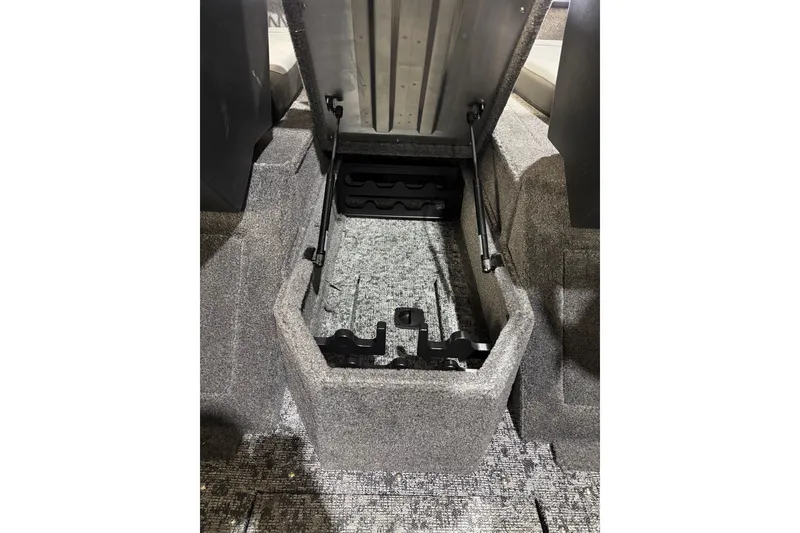 Slide: The Image of 2026 Tracker Pro Guide V-175 Combo boat storage compartment with open lid and carpeted interior. - 11
