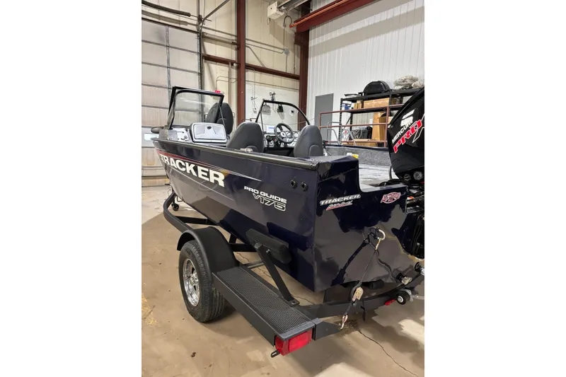 Slide: The Image of 2026 Tracker Pro Guide V-175 Combo boat in a garage setting. - 2
