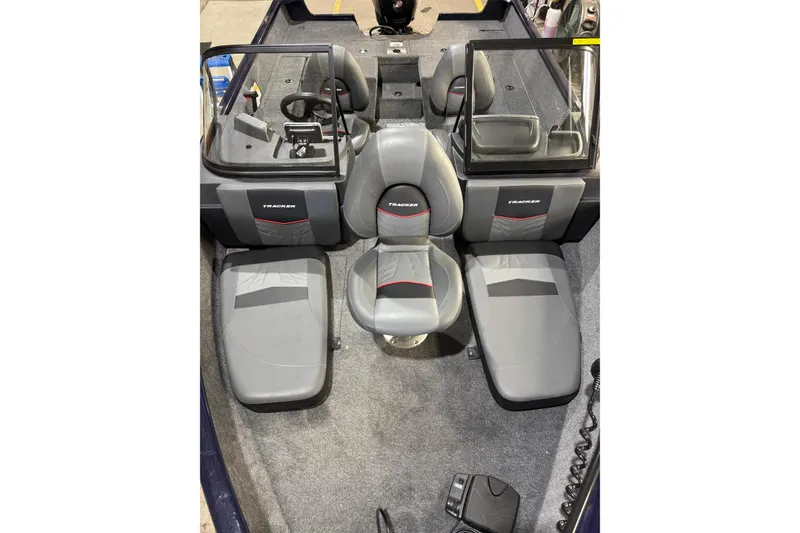 Slide: The Image of 2026 Tracker Pro Guide V-175 Combo boat interior with gray seating and steering console. - 7