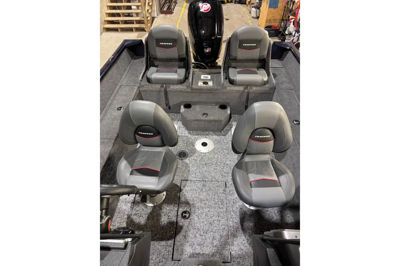Slide: The Image of 2026 Tracker Pro Guide V-175 Combo boat interior with four gray seats. - 8