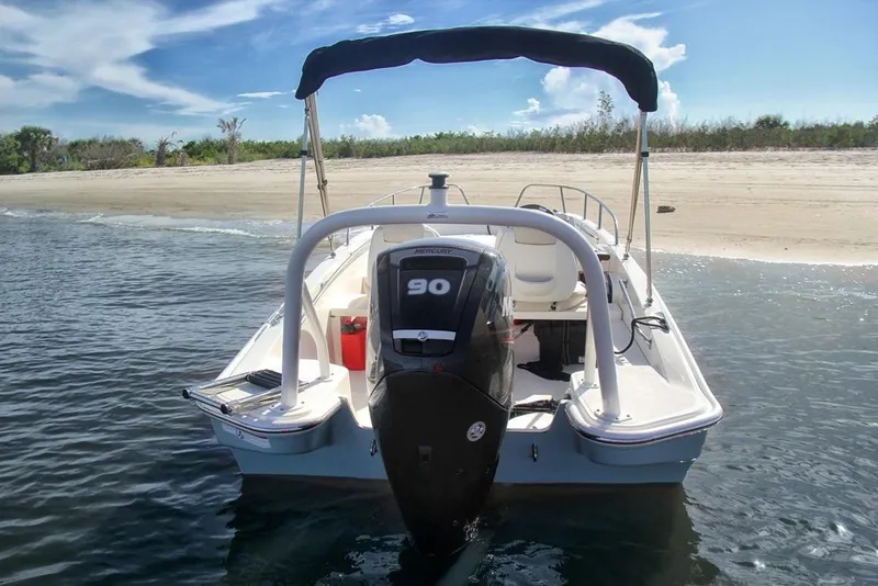 Slide: The Image of Manufacturer Provided Image: 2026 Boston Whaler 160 Super Sport boat near sandy beach, rear view. - 2