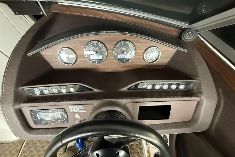 Slide: The Image of Dashboard of a 2014 Cobalt R5 boat with gauges and controls. - 11