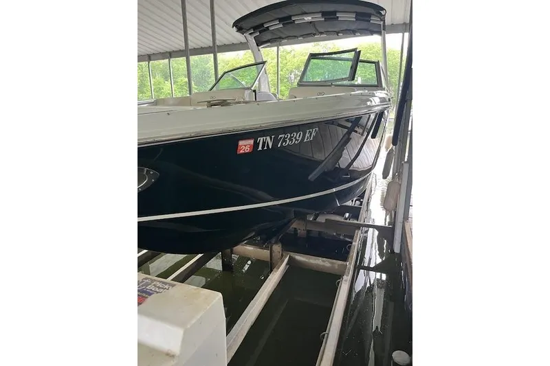 Slide: The Image of 2014 Cobalt R5 boat docked in covered marina, displaying registration number TN 7339 EF. - 13