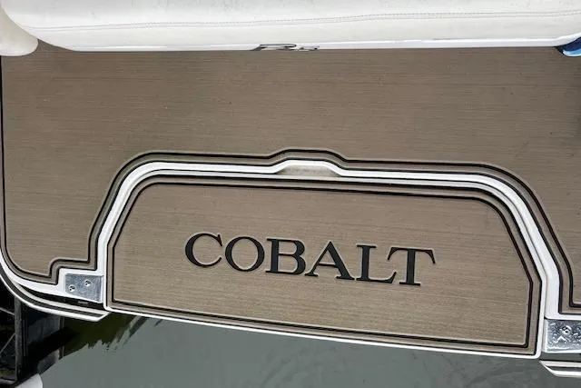 Slide: The Image of Cobalt R5 2014 boat deck with logo, featuring sleek design and wood finish. - 17