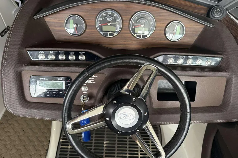 Slide: The Image of Steering wheel and dashboard of a 2014 Cobalt R5 boat with gauges and controls. - 5