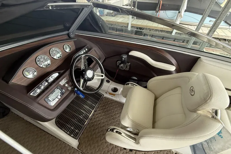 Slide: The Image of Interior of a 2014 Cobalt R5 boat, featuring a sleek dashboard and comfortable captain's chair. - 6