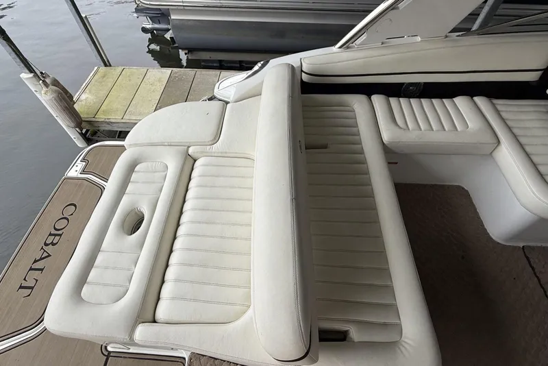 Slide: The Image of 2014 Cobalt R5 boat with white leather seating and dock view. - 8