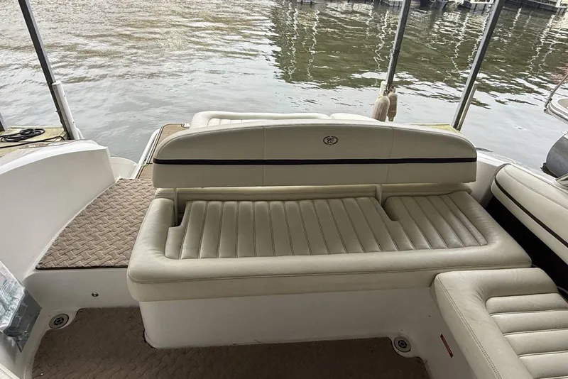 Slide: The Image of 2014 Cobalt R5 boat interior with beige seating by the water. - 9