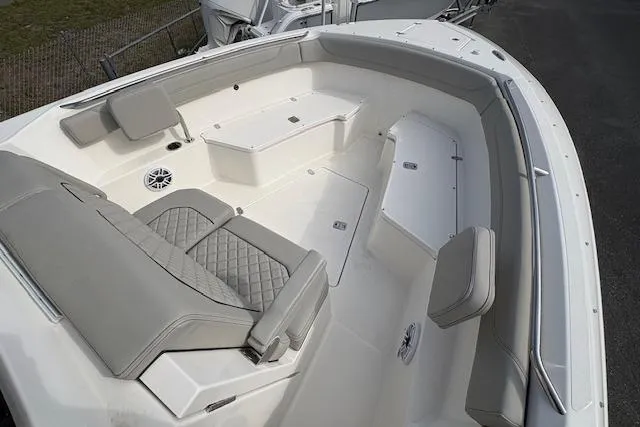 Slide: The Image of 2025 Pursuit S 288 Sport boat interior with cushioned seating and storage compartments. - 11