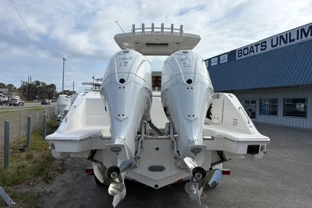 Slide: The Image of 2025 Pursuit S 288 Sport boat with dual outboard engines at dealership. - 2