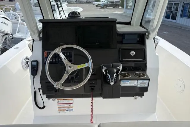 Slide: The Image of Helm of 2025 Pursuit S 288 Sport boat with steering wheel and controls. - 5