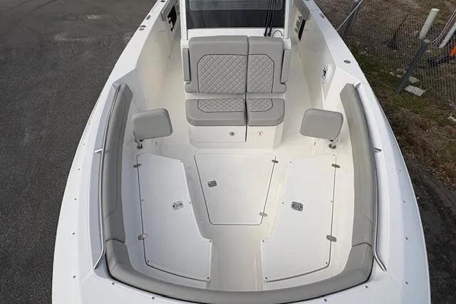 Slide: The Image of 2025 Pursuit S 288 Sport boat interior with cushioned seating and storage compartments. - 7