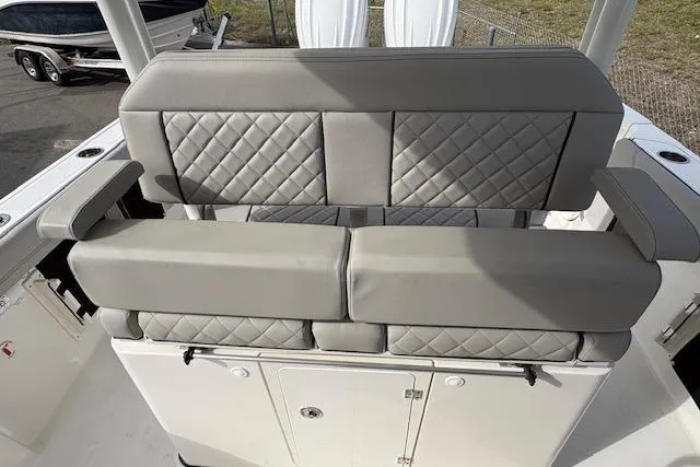 Slide: The Image of 2025 Pursuit S 288 Sport boat with quilted gray seating and storage compartments. - 8
