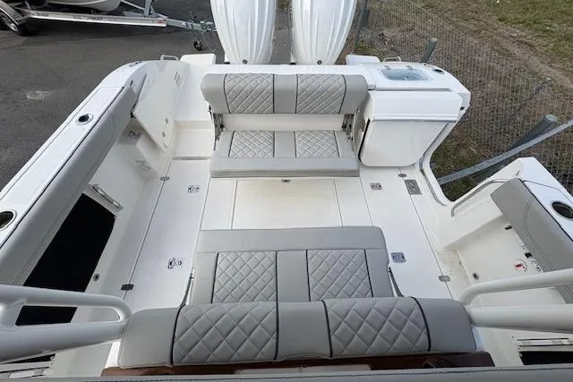 Slide: The Image of 2025 Pursuit S 288 Sport boat interior with cushioned seating and storage compartments. - 9