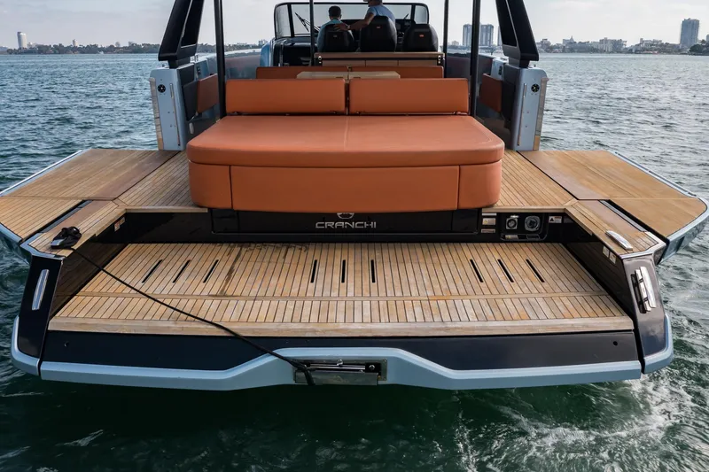 Slide: The Image of 2022 Cranchi A46 Luxury Tender with spacious deck and seating on the water. - 14