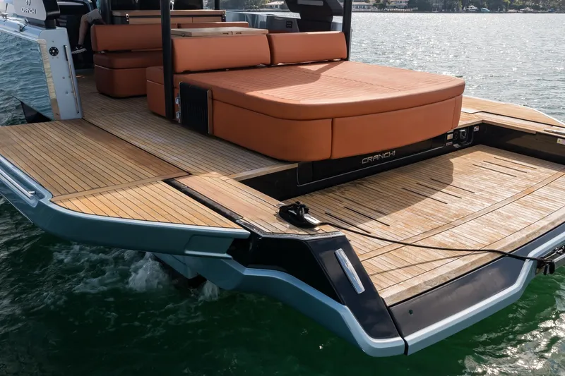 Slide: The Image of 2022 Cranchi A46 Luxury Tender with teak deck and cushioned seating on water. - 15
