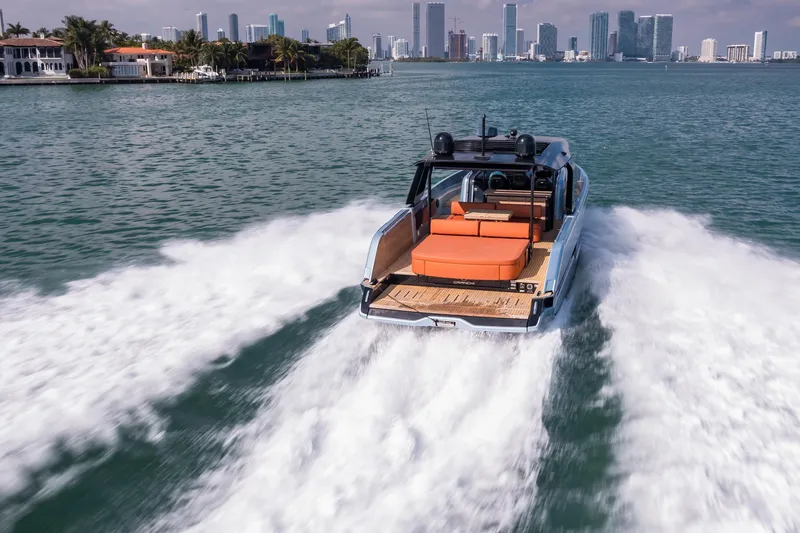 Slide: The Image of 2022 Cranchi A46 Luxury Tender cruising near city skyline, leaving a wake. - 36