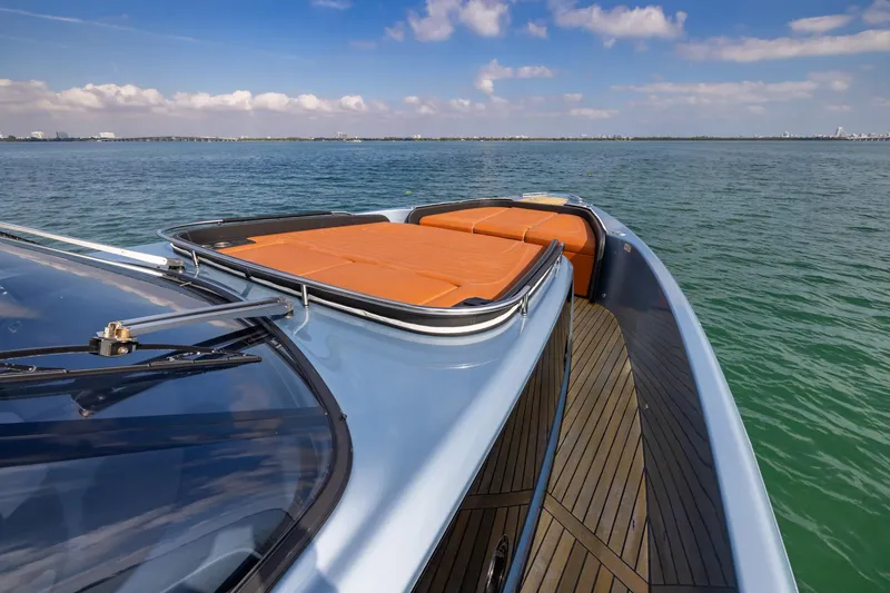 Slide: The Image of 2022 Cranchi A46 Luxury Tender on calm water, featuring sleek design and sunbathing area. - 39