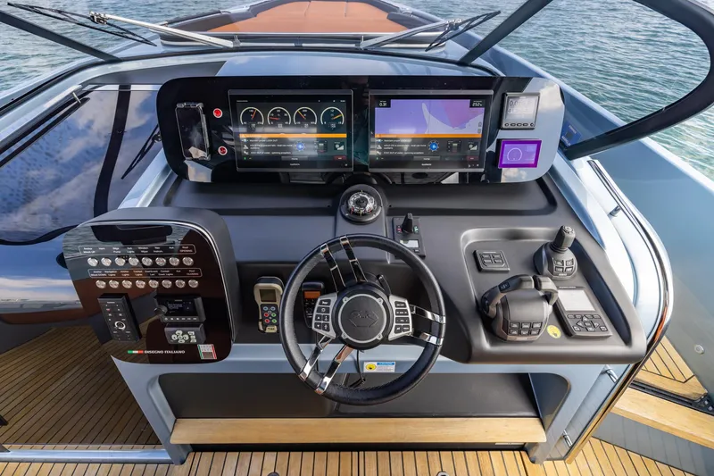 Slide: The Image of 2022 Cranchi A46 Luxury Tender helm with advanced navigation controls and sleek design. - 46