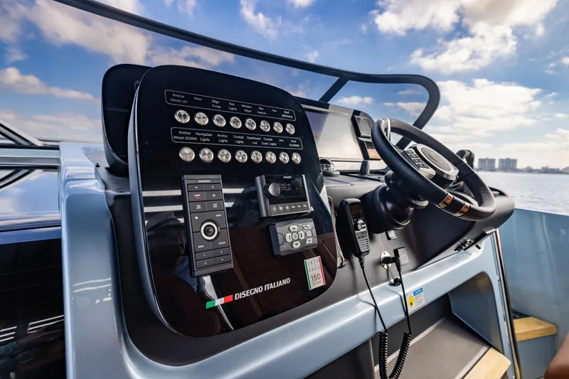 Slide: The Image of Control panel of 2022 Cranchi A46 Luxury Tender with steering wheel and navigation controls. - 48