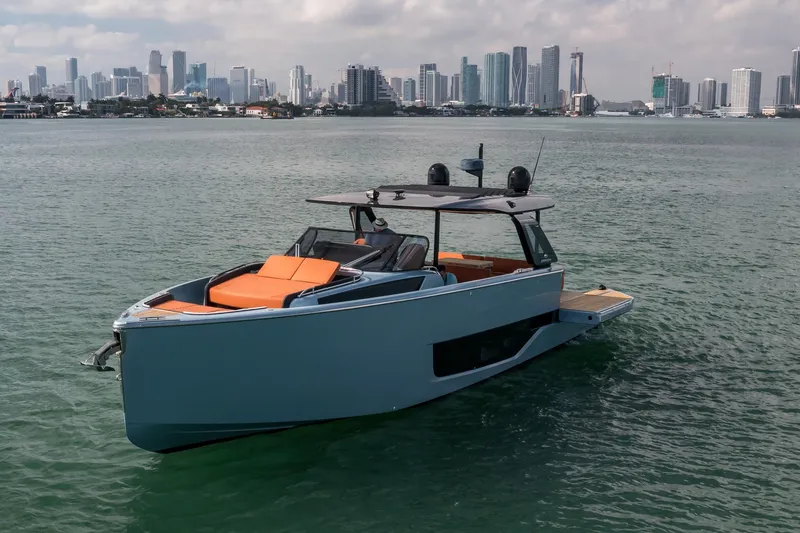 Slide: The Image of 2022 Cranchi A46 Luxury Tender yacht on water with city skyline backdrop. - 5