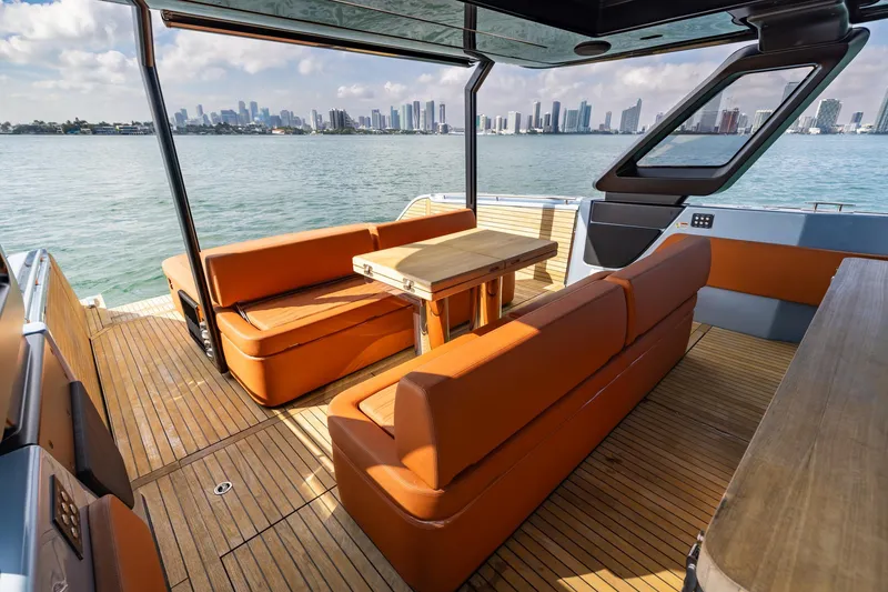 Slide: The Image of Luxurious 2022 Cranchi A46 Tender with elegant seating and scenic waterfront view. - 52