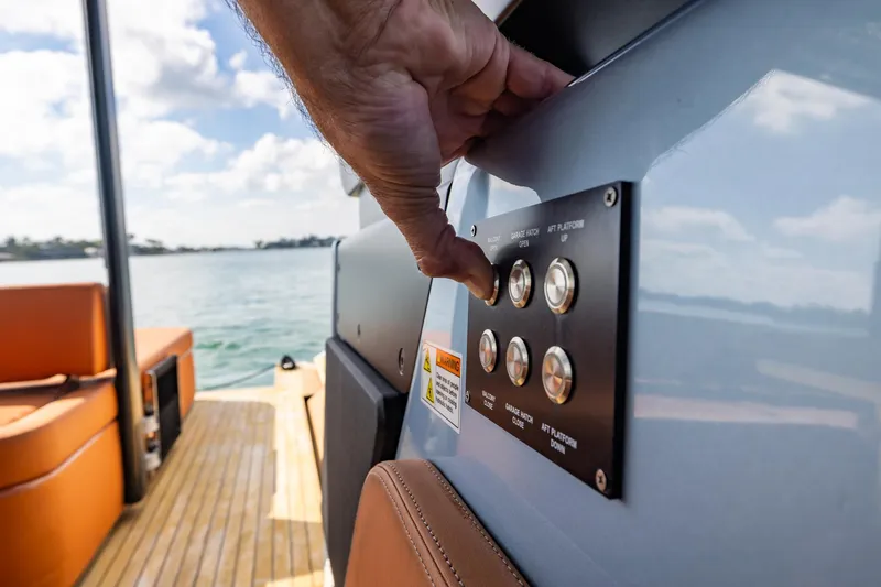 Slide: The Image of Hand operating control panel on 2022 Cranchi A46 Luxury Tender yacht. - 53