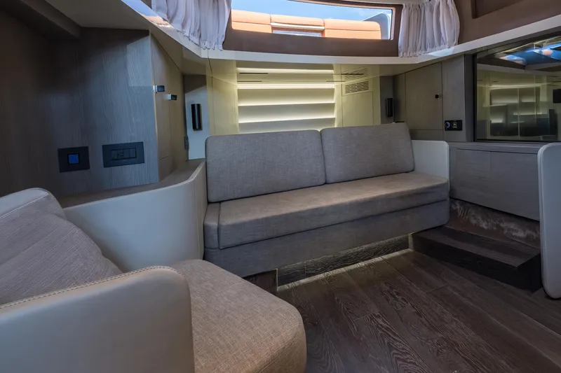 Slide: The Image of Interior of 2022 Cranchi A46 Luxury Tender with modern seating and wood flooring. - 59