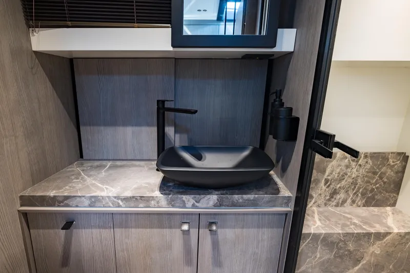Slide: The Image of Modern bathroom interior on 2022 Cranchi A46 Luxury Tender yacht, featuring sleek black sink. - 68