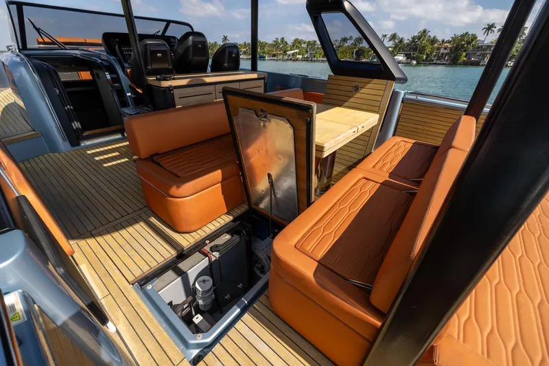Slide: The Image of 2022 Cranchi A46 Luxury Tender interior with orange seating and open storage compartment. - 69