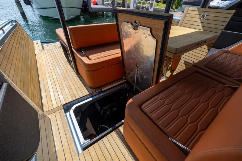 Slide: The Image of 2022 Cranchi A46 Luxury Tender interior with open engine hatch, teak flooring, and leather seating. - 70