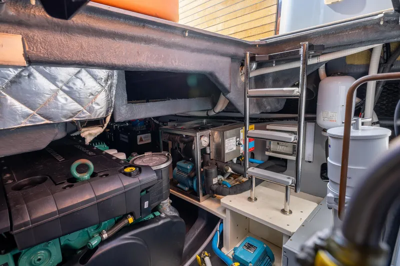 Slide: The Image of Engine room of 2022 Cranchi A46 Luxury Tender, showcasing mechanical components and ladder access. - 79