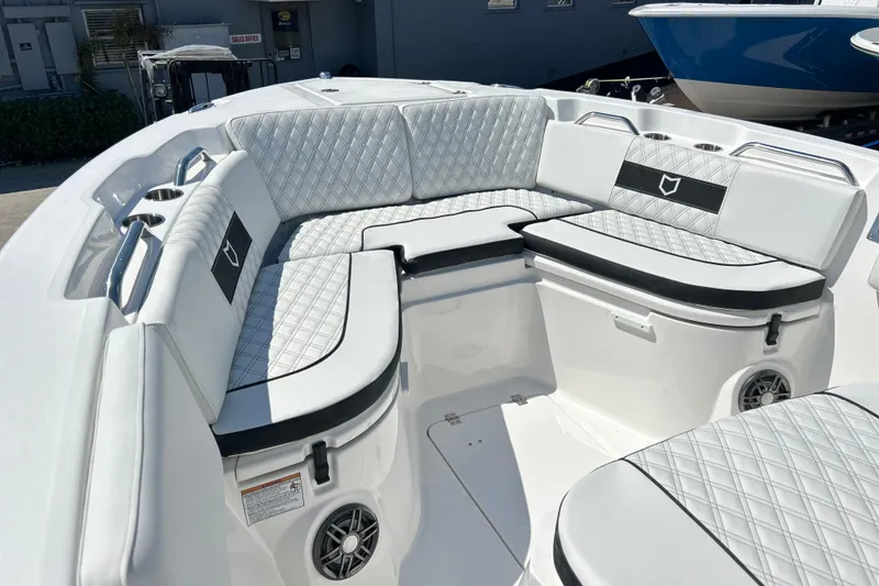 Slide: The Image of 2026 Sea Fox 268 Commander boat interior with white quilted seating and cup holders. - 19