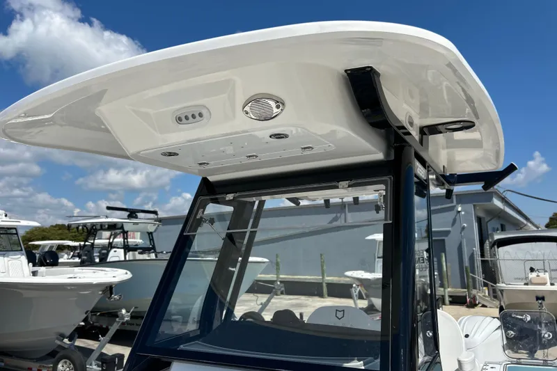 Slide: The Image of 2026 Sea Fox 268 Commander boat with T-top and console, under a clear blue sky. - 24