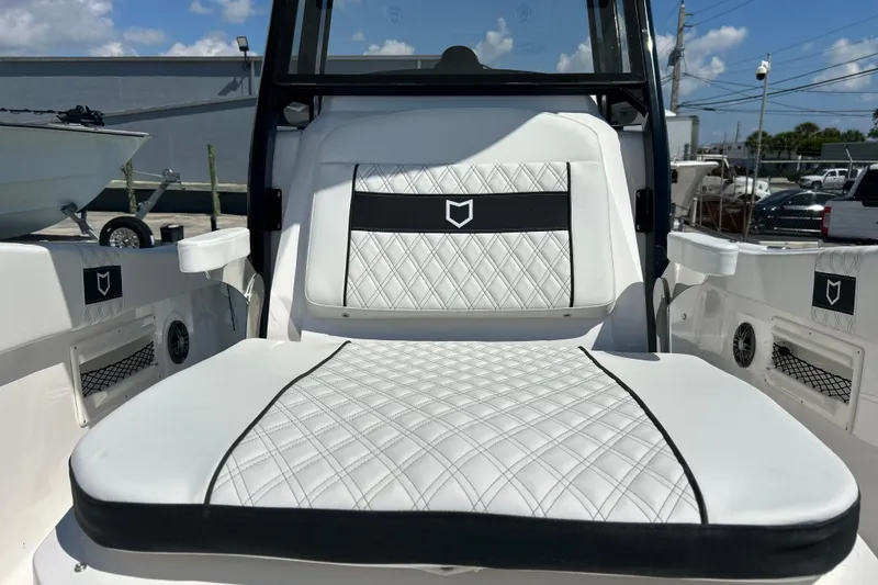 Slide: The Image of 2026 Sea Fox 268 Commander boat seat with diamond-stitched upholstery under a sunny sky. - 26