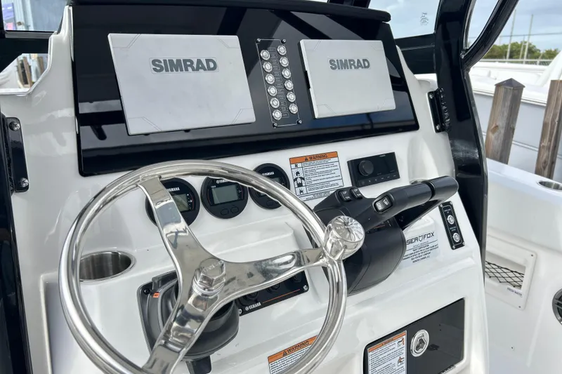 Slide: The Image of 2026 Sea Fox 268 Commander helm with dual Simrad displays and Yamaha controls. - 27
