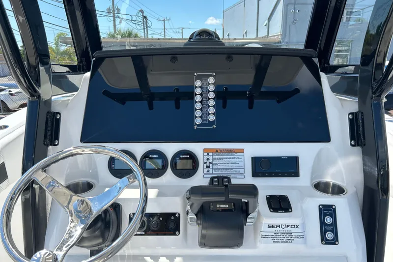 Slide: The Image of 2026 Sea Fox 268 Commander boat dashboard with steering wheel and control panel. - 34