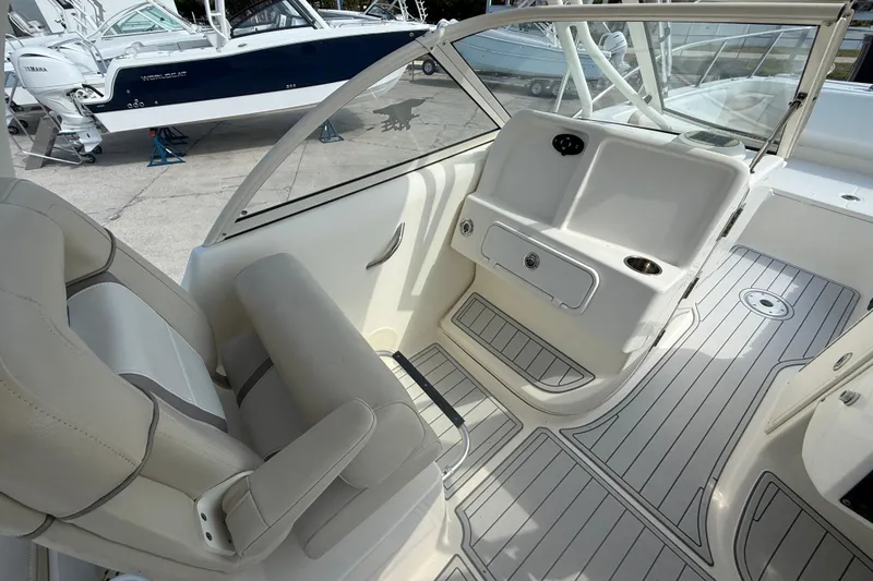Slide: The Image of Interior of a 2016 World Cat 255 DC boat with seating and dashboard. - 11