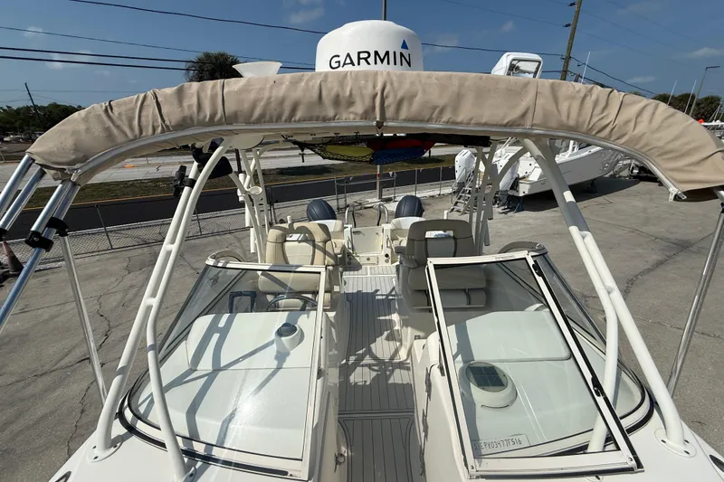 Slide: The Image of 2016 World Cat 255 DC boat with Garmin equipment, docked outdoors under clear skies. - 17