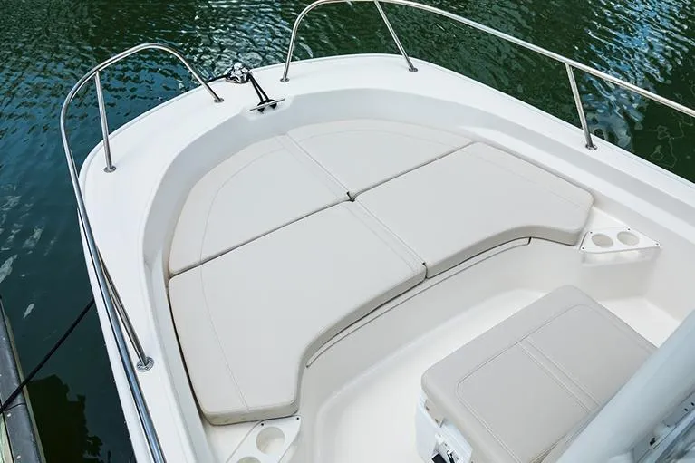 Slide: The Image of Manufacturer Provided Image: 2026 Boston Whaler 190 Montauk boat interior with cushioned seating on calm water. - 2