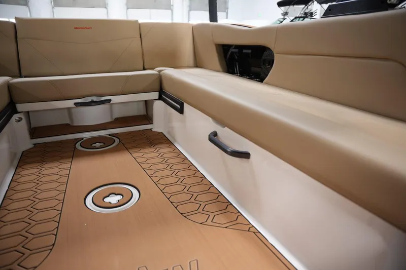 Slide: The Image of 2025 MasterCraft NXT24 boat interior with tan seating and stylish flooring. - 10