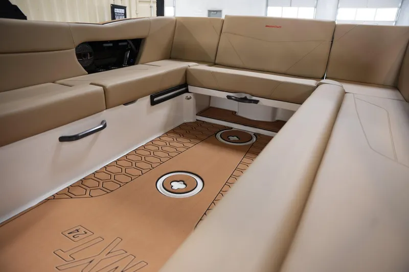 Slide: The Image of Interior of 2025 MasterCraft NXT24 boat with tan seating and stylish flooring. - 11