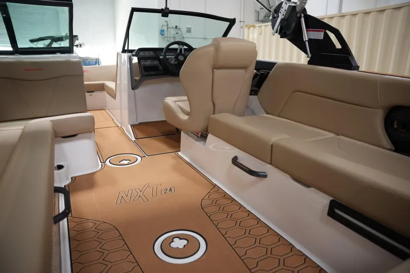 Slide: The Image of Interior of 2025 MasterCraft NXT24 boat with tan seating and modern dashboard. - 12