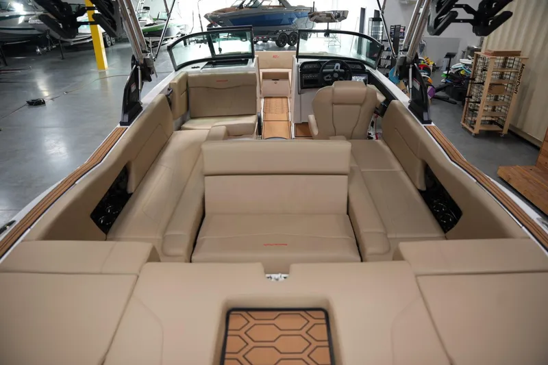 Slide: The Image of 2025 MasterCraft NXT24 boat interior with beige seating and modern dashboard. - 15