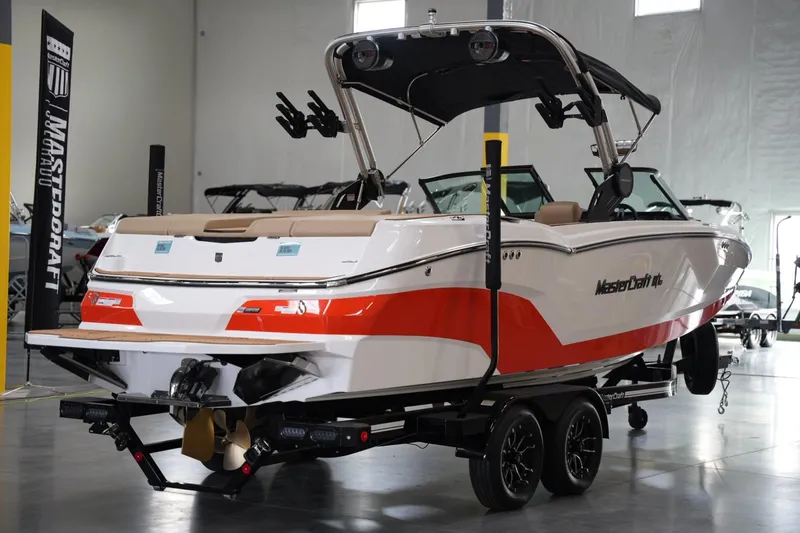 Slide: The Image of 2025 MasterCraft NXT24 boat in showroom, featuring sleek design and vibrant red accents. - 4
