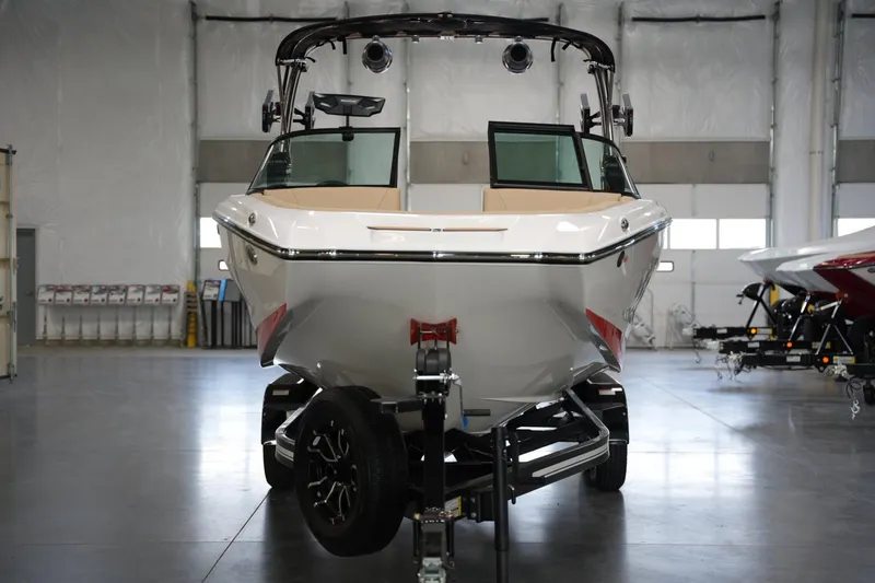 Slide: The Image of 2025 MasterCraft NXT24 boat in showroom, front view on trailer. - 6