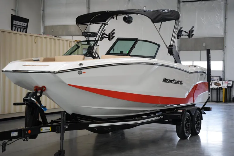 Slide: The Image of 2025 MasterCraft NXT24 boat in showroom, featuring sleek design and vibrant red accents. - 7