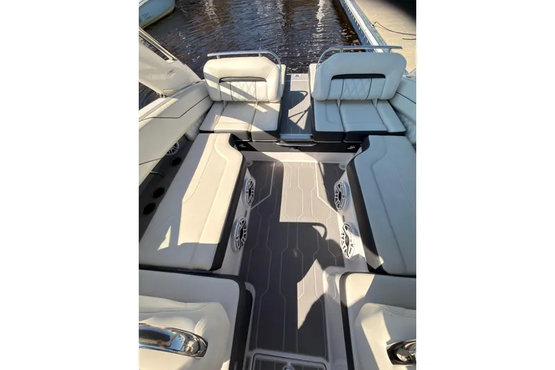 Slide: The Image of Luxurious seating area on a 2019 Regal LS4 boat, featuring elegant upholstery and spacious design. - 13