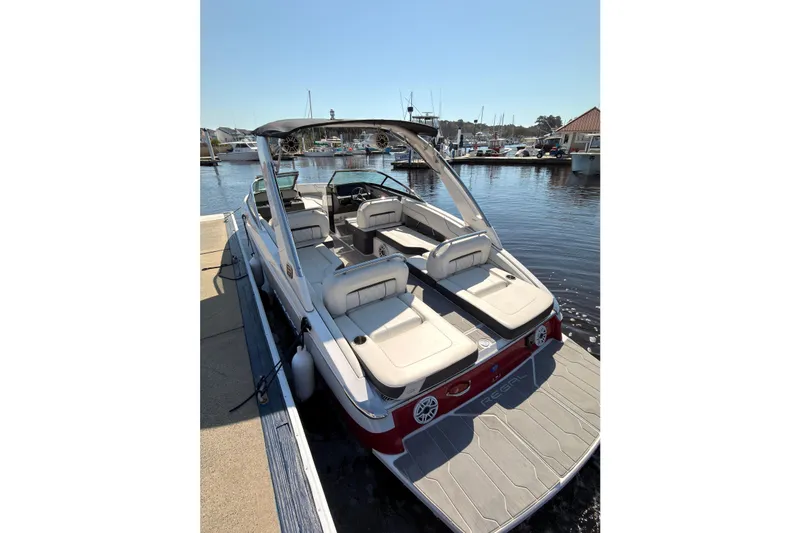 Slide: The Image of 2019 Regal LS4 boat docked at marina, featuring spacious seating and sleek design. - 3
